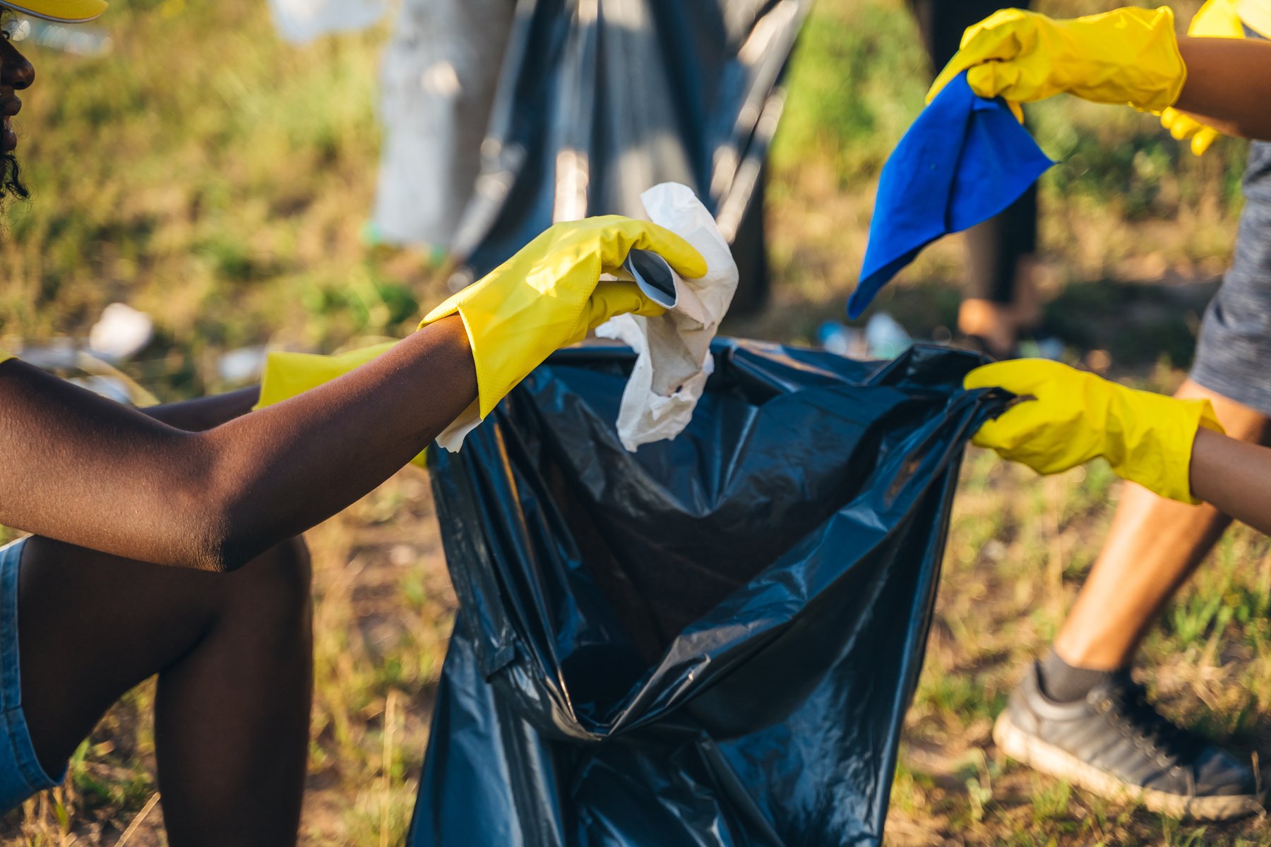 People cleaning up garbage in nature